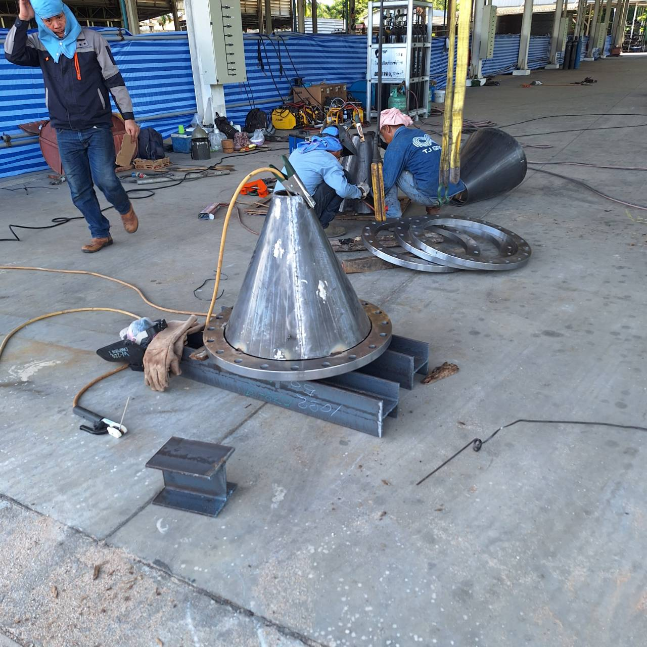 Phenovate crew fabricating a stainless cone section in the workshop