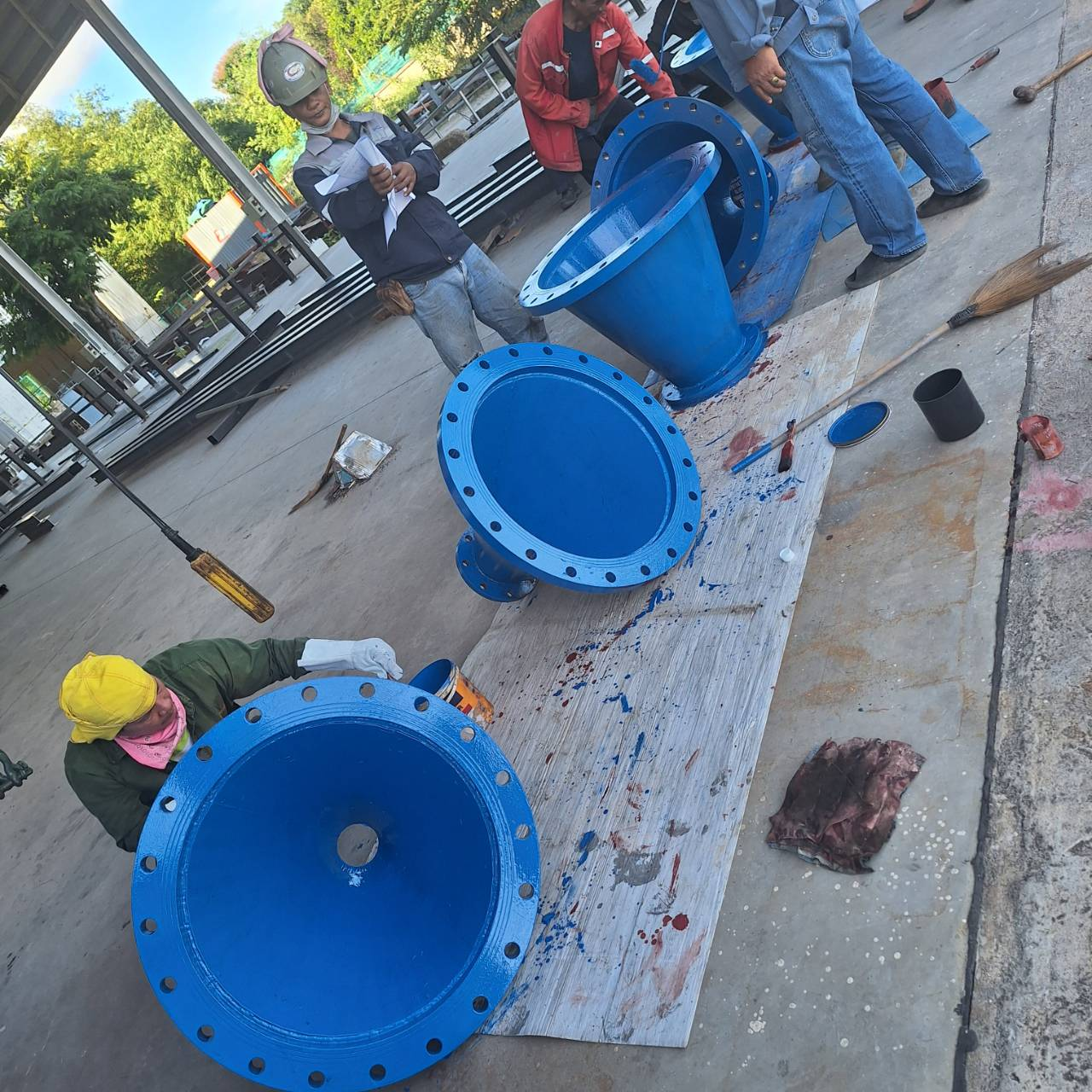 Blue epoxy-coated flanged pipe fittings ready for dispatch